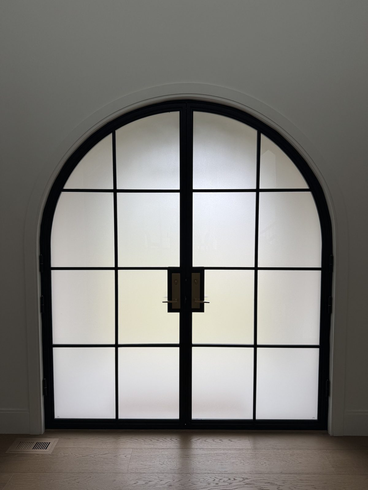 Arched steel entry door