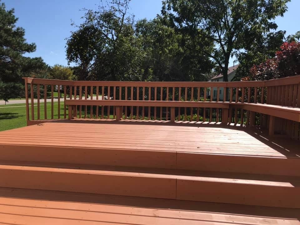 Backyard deck with built-in bench, cedar stain